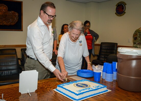 Patricia Henrich cuts a cake celebrating her retirement after 67 years of federal civilian service following her retirement ceremony at Edwards Air Force Base, Calif., May 31. (U.S. Air Force photo by Giancarlo Casem)