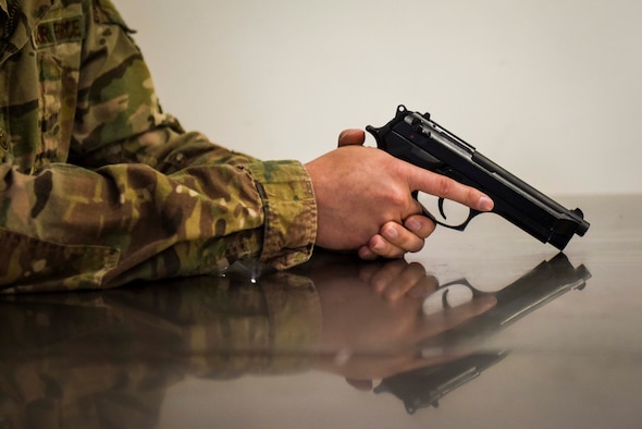 U.S. Air Force Staff Sgt. James Shott, a shooting contest participant, inspects an M9 pistol prior to using it during the Excellence in Competition event Oct. 28, 2019, at Incirlik Air Base, Turkey. Airmen from various units across Incirlik competed to become one of the top 10 out of 100 contenders in the event hosted by the 39th Security Forces Squadron. (U.S. Air Force photo by Staff Sgt. Joshua Magbanua)