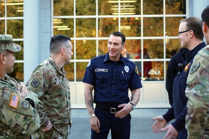 Sgt. 1st Class Nick Van Kirk, a logistics and decontamination non-commissioned officer with the 10th Civil Support Team and volunteer firefighter with South Bay Fire Department, talks with his two commanders before a ceremony Oct. 10, 2019, in Olympia, Washington.