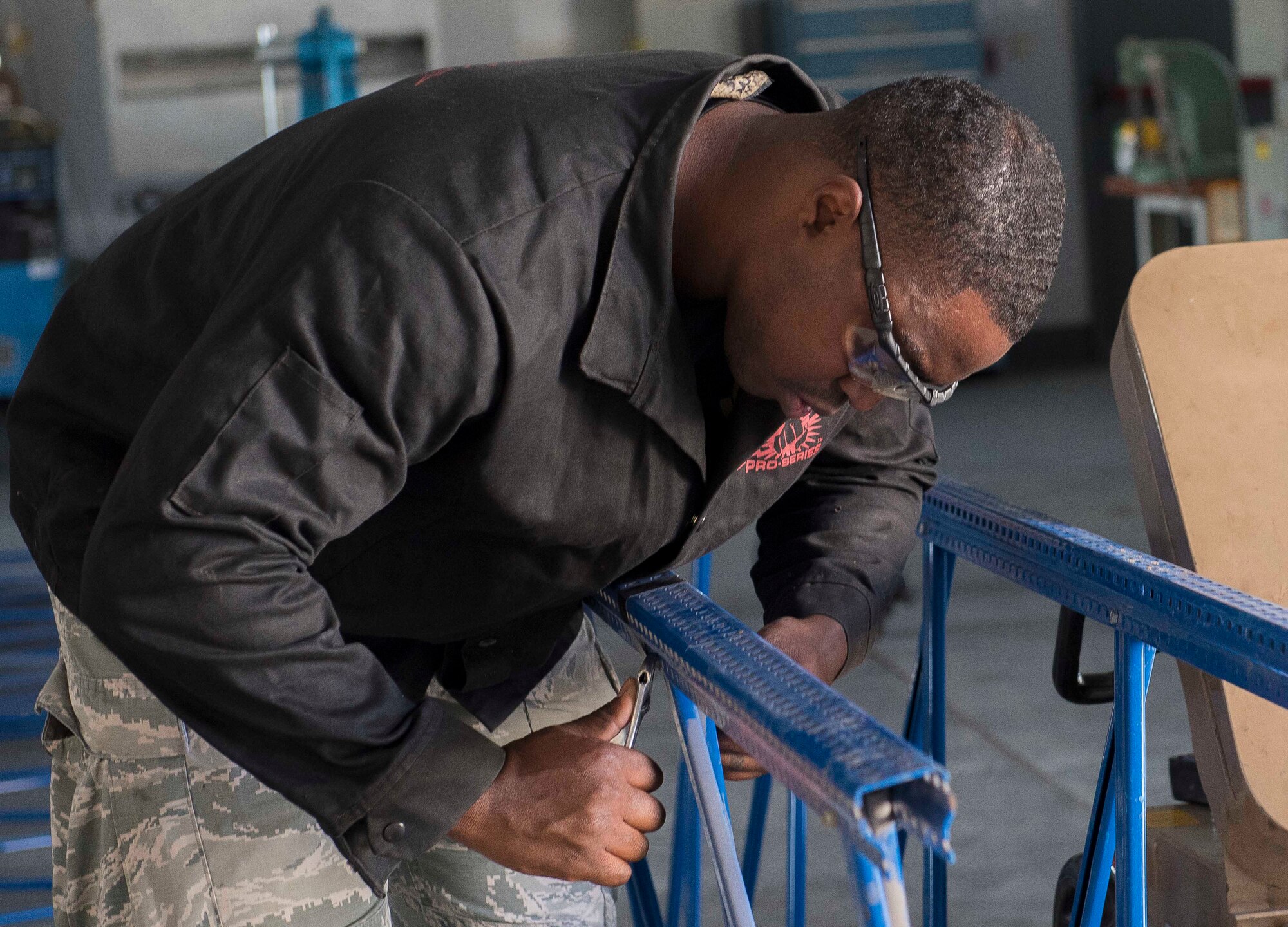U.S. Air Force Tech. Sgt. Joshua Colley, 39th Maintenance Squadron noncommissioned officer in charge of aircraft metals technology, removes a bolt prior to using a plasma cutter to cut excess material from a metal railing, Oct. 25, 2019, at Incirlik Air Base, Turkey. Removing a bolt makes it easier to cut through the metal by giving the technician less material to cut through. (U.S. Air Force photo by Staff Sgt. Trevor Rhynes)