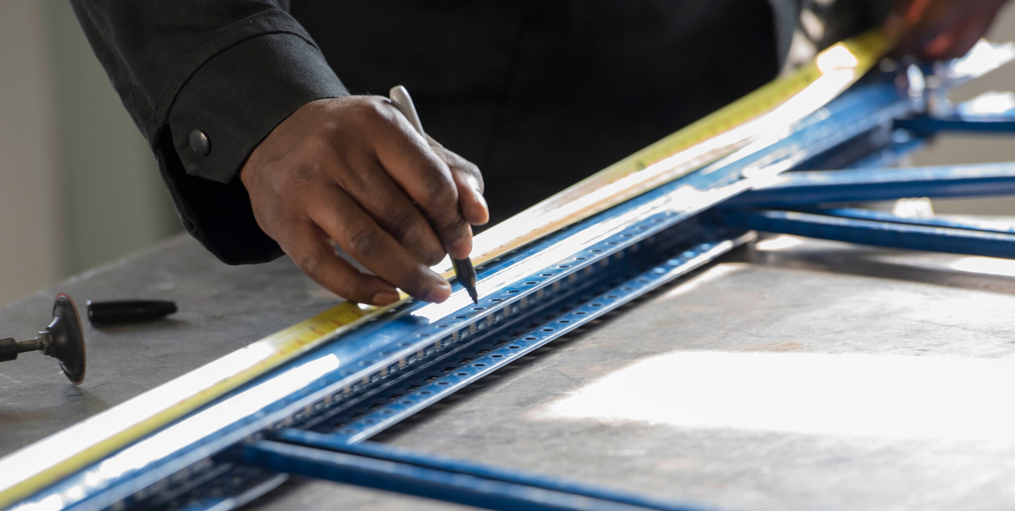 U.S. Air Force Tech. Sgt. Joshua Colley, 39th Maintenance Squadron noncommissioned officer in charge of aircraft metals technology, marks a measurement on a railing for the 39th Logistics Readiness Squadron, Oct. 25, 2019, at Incirlik Air Base, Turkey. Aircraft metals technicians work with customers to ensure the product requested fits their specifications. (U.S. Air Force photo by Staff Sgt. Trevor Rhynes)