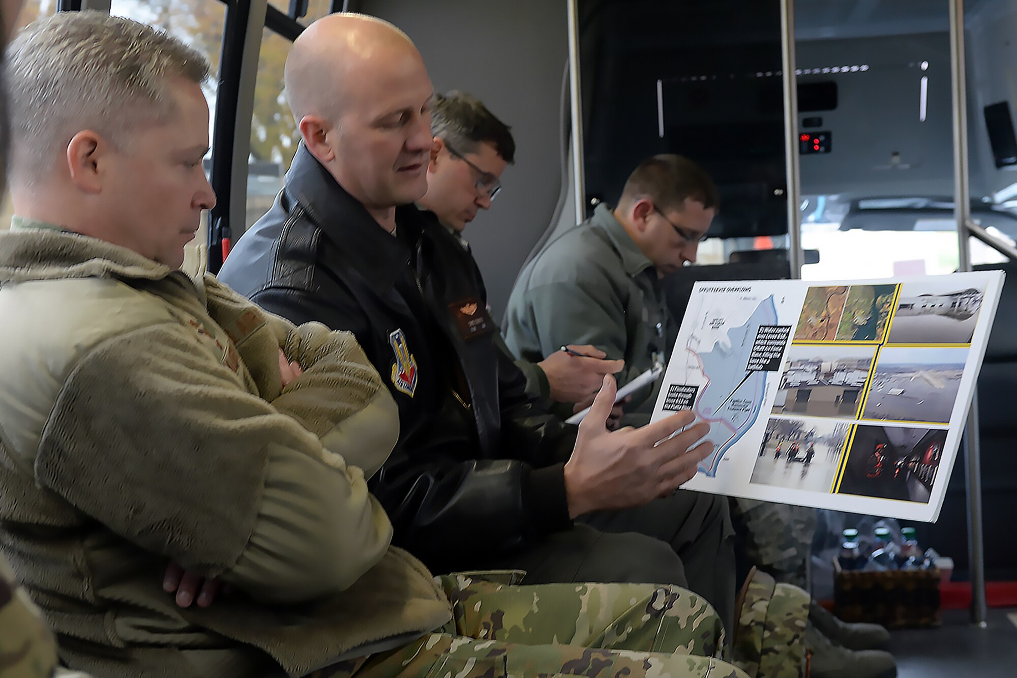 (Left) Lt. Gen. Timothy Haugh, Sixteenth Air Force (Air Forces Cyber) commander, listens to Lt. Col. Chris Conover, 55th Wing Program Management Office director, as he explains the devastation of the March 2019 flood.