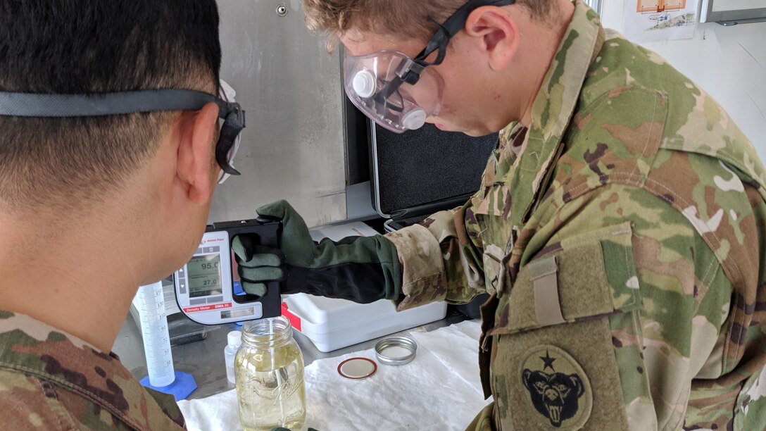 Pfc. Stefan Moreno, petroleum supply specialist, 574th Composite Suppy Company, performs an American Petroleum Institute (API) gravity test on a batch of fuel at Erbil, Iraq, Oct. 16, 2019. The API gravity test measures how heavy or light petroleum is compared to water, which is used to compare densities of petroleum liquids.