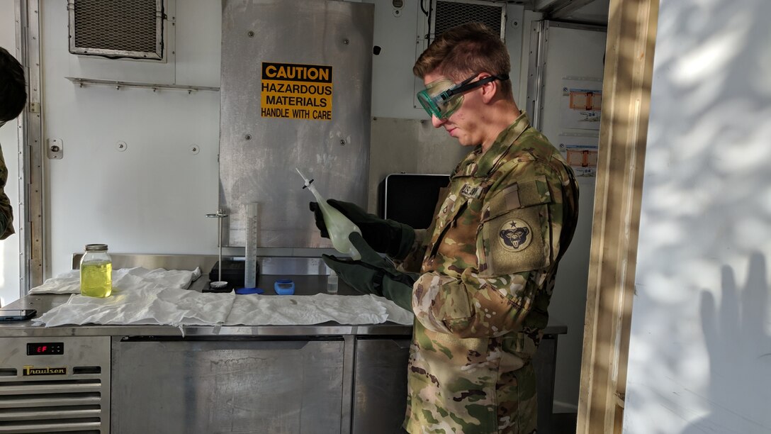 Pfc. Stefan Moreno, petroleum supply specialist, 574th Composite Supply Company, conducts a visual sight test on a batch of fuel at Erbil, Iraq, Oct. 16, 2019. Moreno is making sure the fuel is clear of debris by checking for contaminants and discoloration.