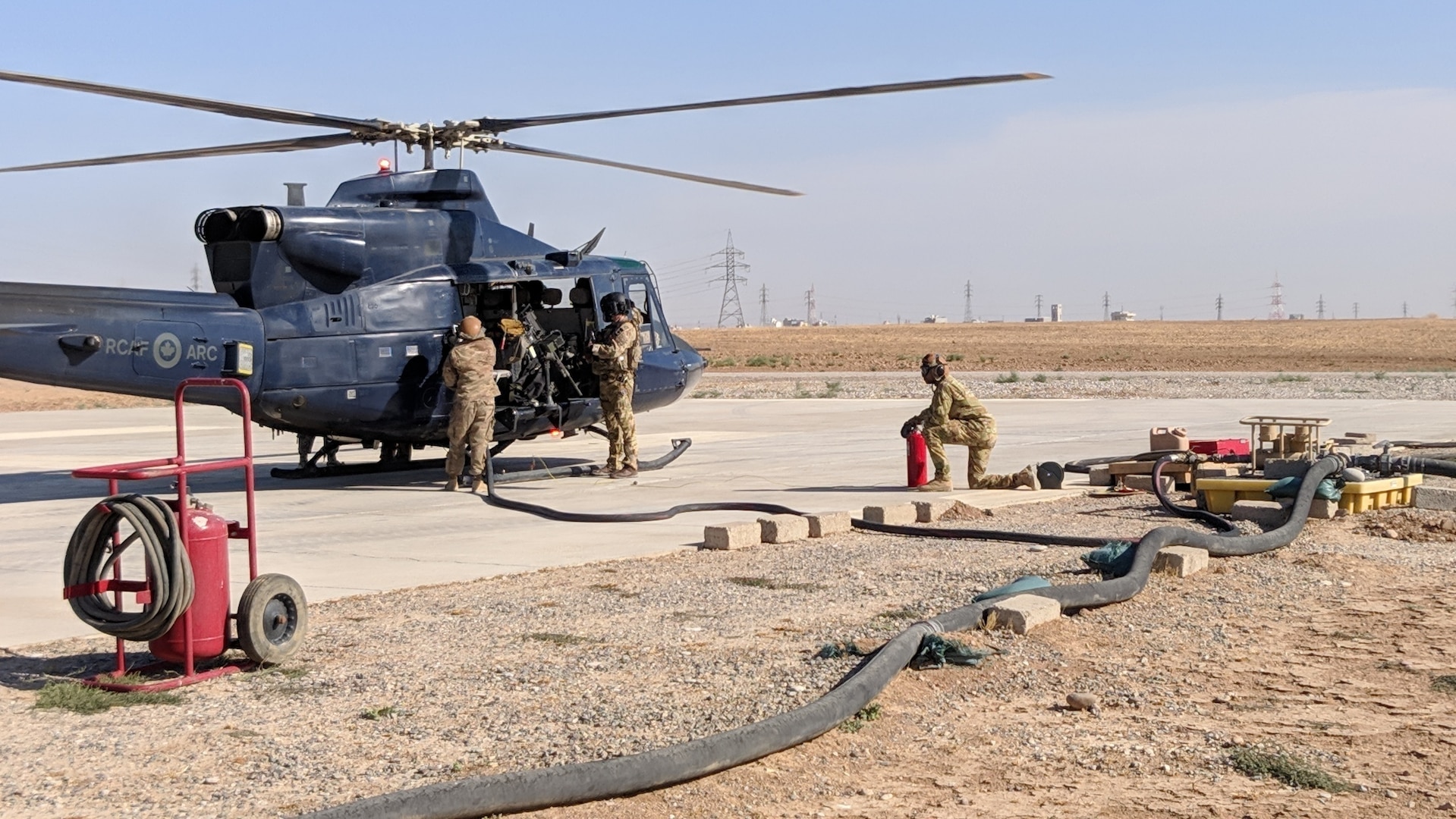 Spc. Clara Zurita, motor transport operator, and Spc. Godswill Orzabal, petroleum supply specialist, 574th Composite Supply Company, fuel up an NH90 helicopter at Erbil, Iraq, Oct. 15, 2019.