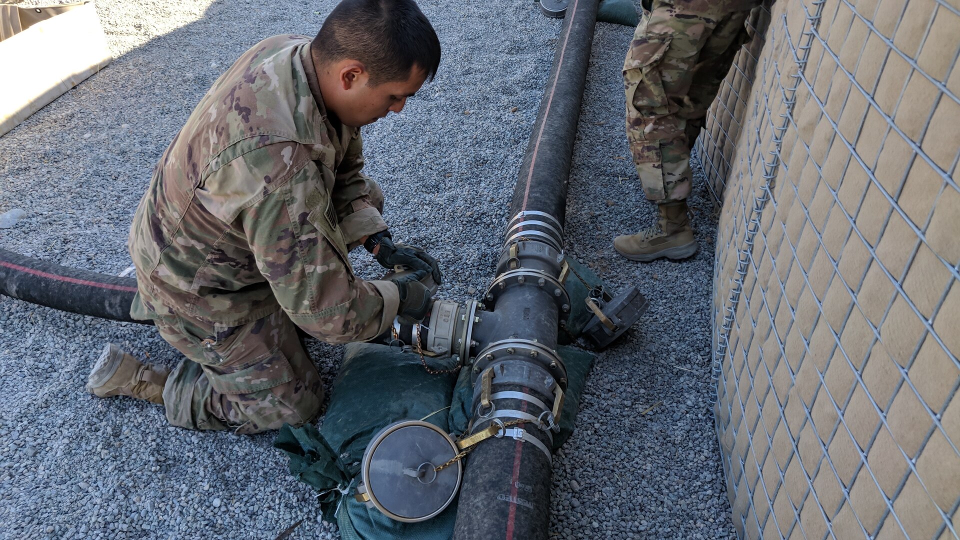 Spc. Godswill Orzabal, petroleum supply specialist, 574th Composite Supply Company, closes a valve at the fuel station supply point at Erbil, Iraq, Oct. 15, 2019.