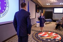 U.S. Air Force Master Sgt. Christina Anders takes the senior noncommissioned officer charges, administered by Senior Master Sgt. Matthew Larsen, who served with Anders at the 821st Contingency Response Squadron at Travis Air Force Base, Ca., during a promotion ceremony at  Joint Task Force Civil Support (JTF-CS) headquarters. Anders was pinned by her son, daughter and Aaron Plichta, a member of JTF-CS. (Official DoD photo by Mass Communication Specialist 3rd Class Michael Redd/RELEASED)