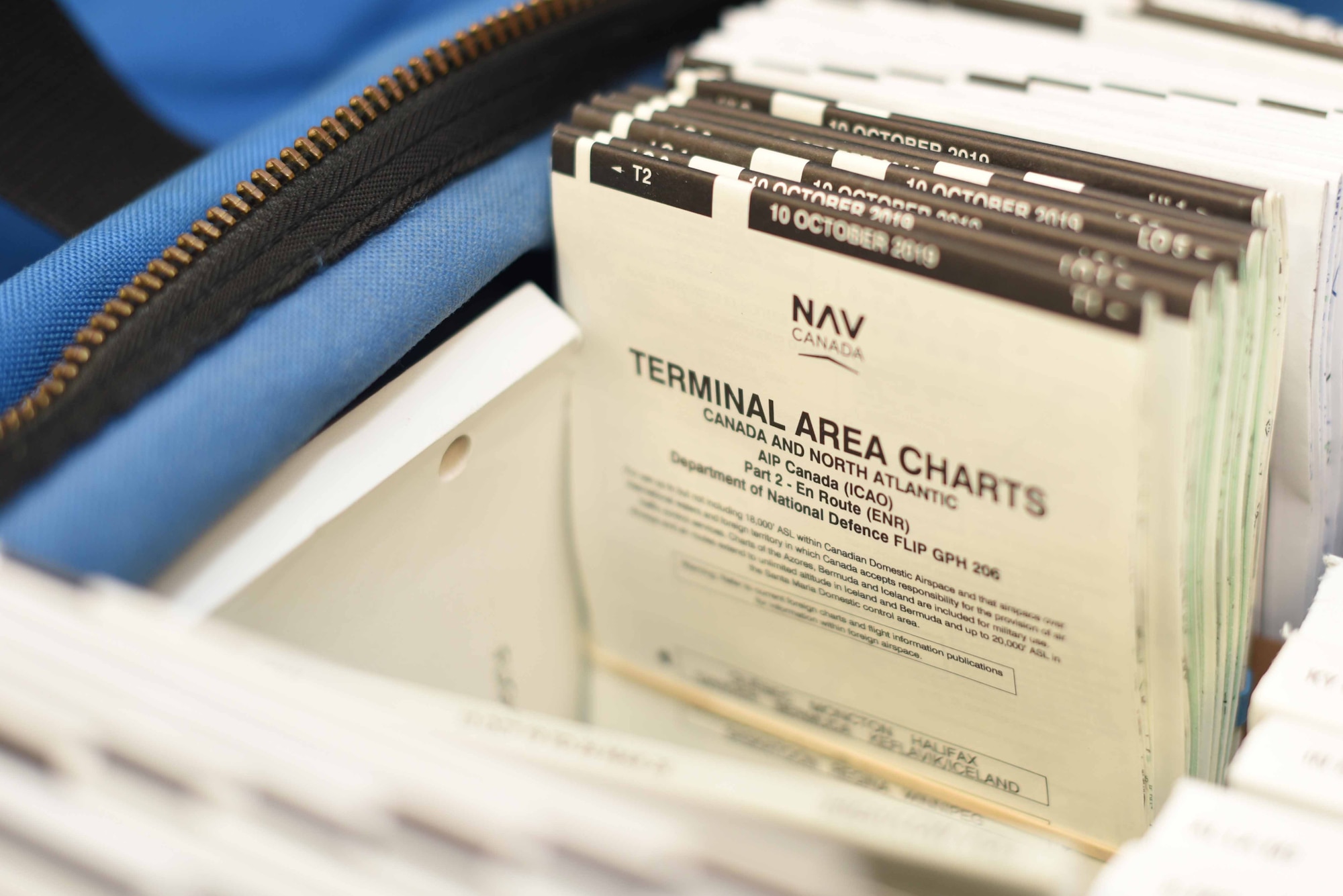 A packet of terminal area charts sit in a Worldwide Flight Information Publication bag Oct. 30, 2019, at McConnell Air Force Base, Kan. These bags hold an average of 74 FLIP books that give pilots all of the information they need during a flight, which includes authorized airports, maps and terrain data. (U.S. Air Force photo by Airman 1st Class Alexi Bosarge)