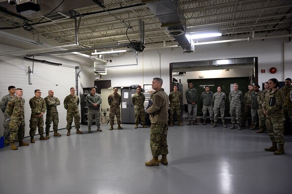 Lt. Gen. Timothy Haugh, Sixteenth Air Force (Air Forces Cyber) commander, talks with Airmen from the 55th Strategic Communication Squadron Airmen inside their Tactical Radio Bay during a visit here Oct. 30, 2019.