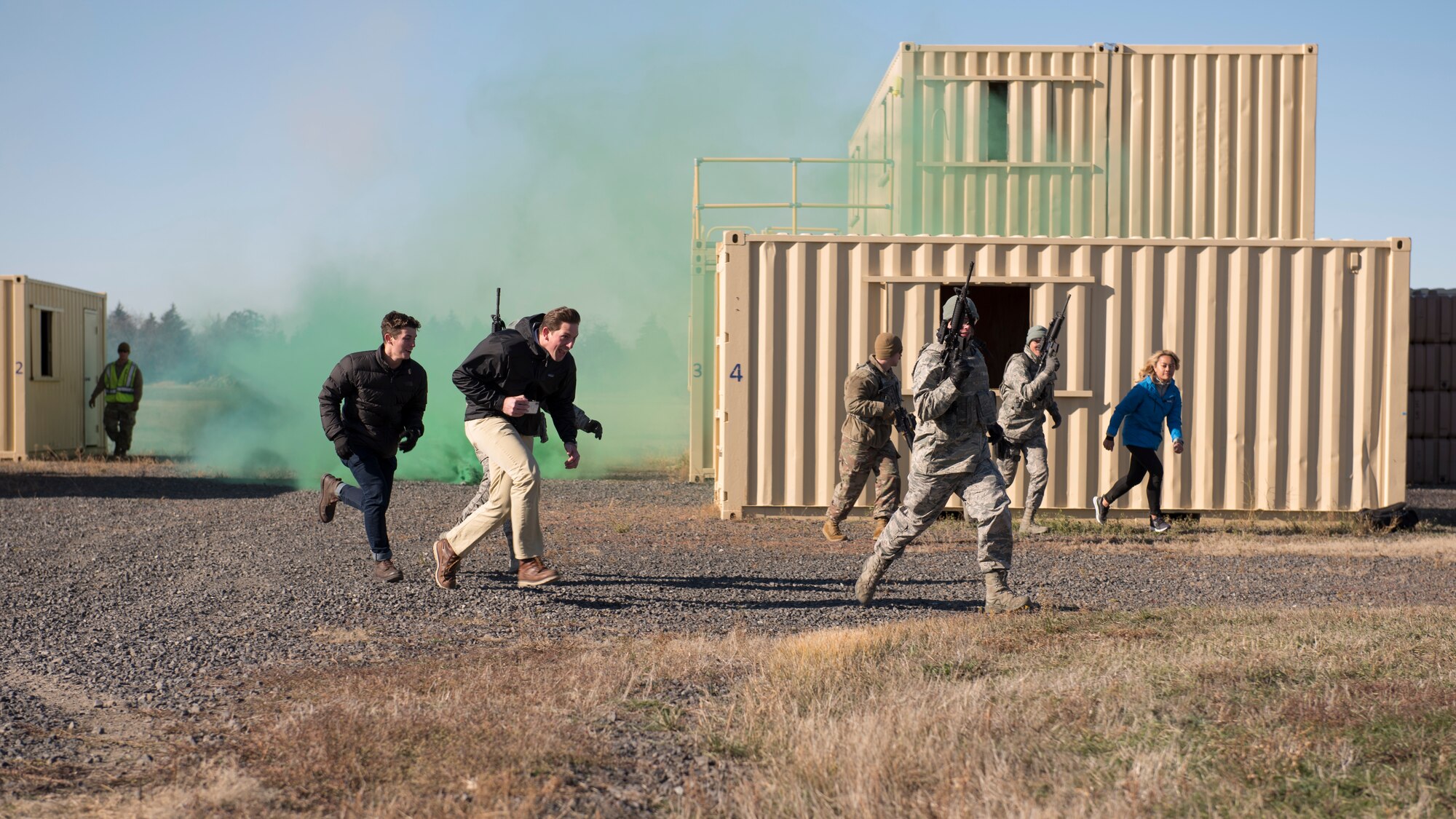 92nd Security Forces Squadron Airmen evacuate local media members to a safe area after a simulated explosion training exercise during a Year of the Defender media day event at Fairchild Air Force Base, Washington, Oct. 29, 2019. Security forces Airmen are charged with training and maintaining combat readiness on weapons and protective gear for all Airmen, ensuring everyone is deployment ready. (U.S. Air Force photo by Senior Airman Ryan Lackey)