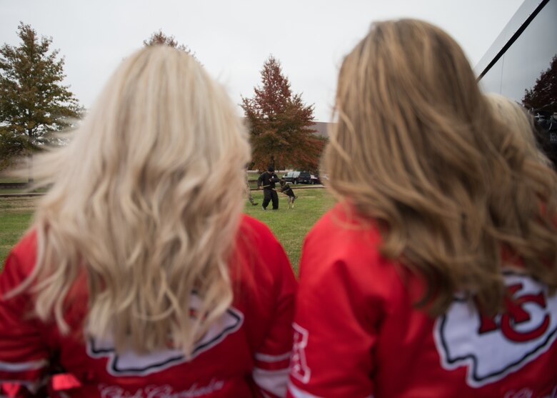 National Football League’s Kansas City Chiefs cheerleaders watch a military working dog demonstration by the 509th Security Forces Squadron members.