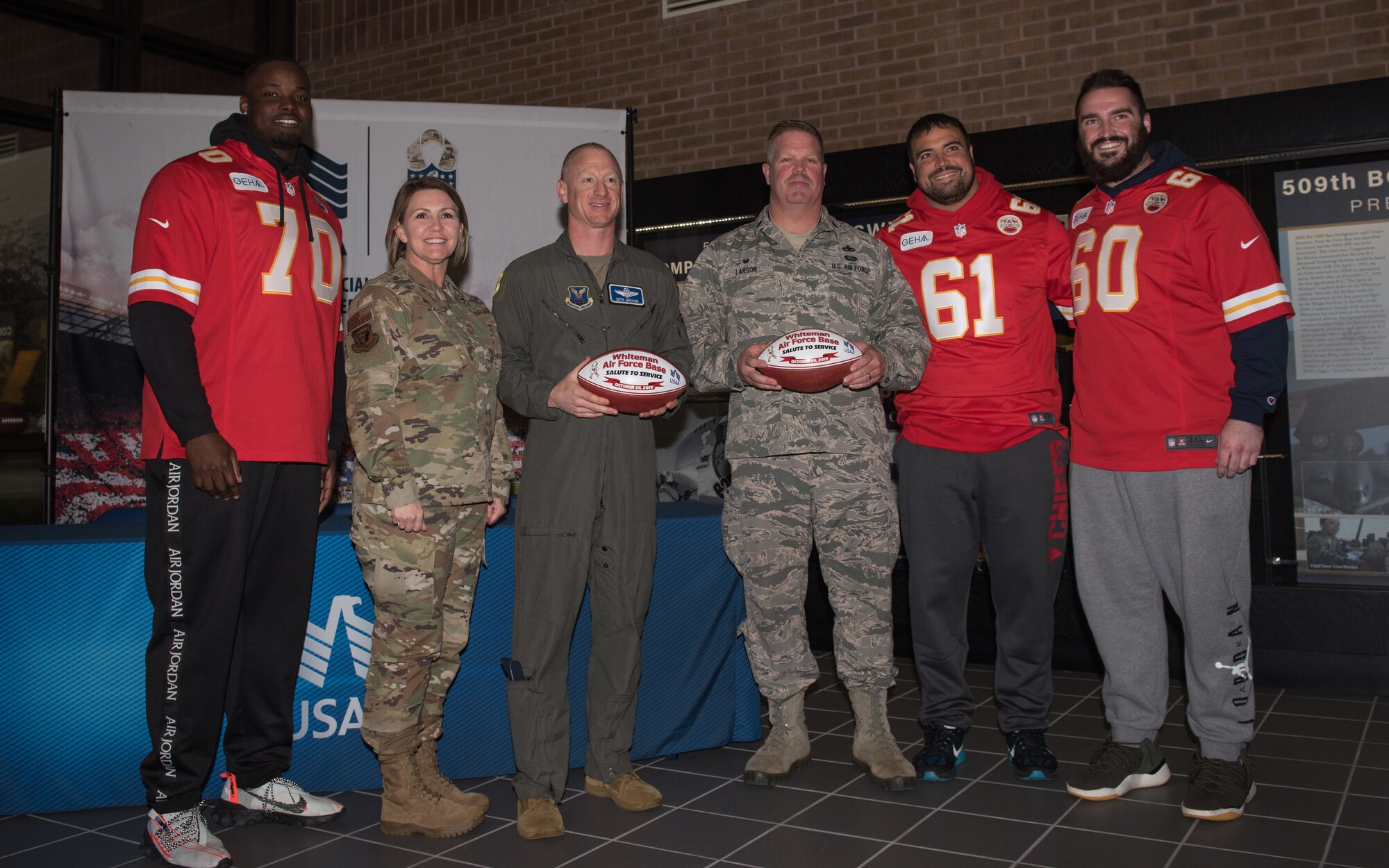National Football League’s Kansas City Chiefs present game balls to U.S. Air Force Col. Seth Graham, the 509th Bomb Wing vice commander, and Lt. Col. Chard Larson, the 131st Aircraft Maintenance Squadron commander, during a visit to Whiteman Air Force Base, Missouri, Oct. 29, 2019.