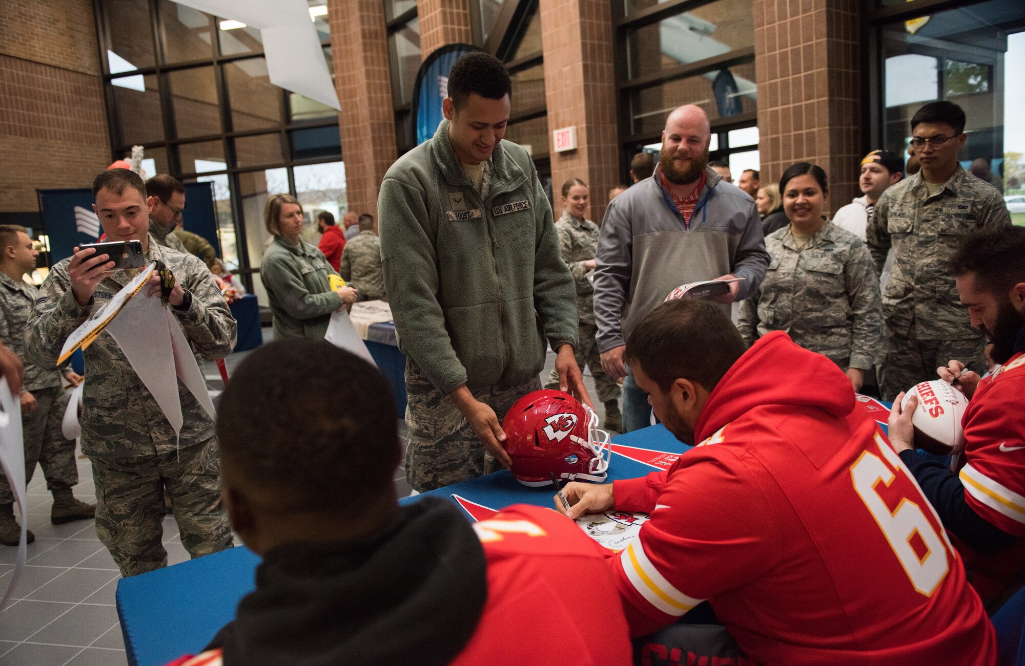 National Football League’s Kansas City Chiefs offensive linemen meet with fans and sign autographs during a visit at Whiteman Air Force Base, Missouri, Oct. 29, 2019.