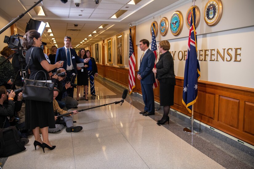 A  man and woman answer questions on camera.