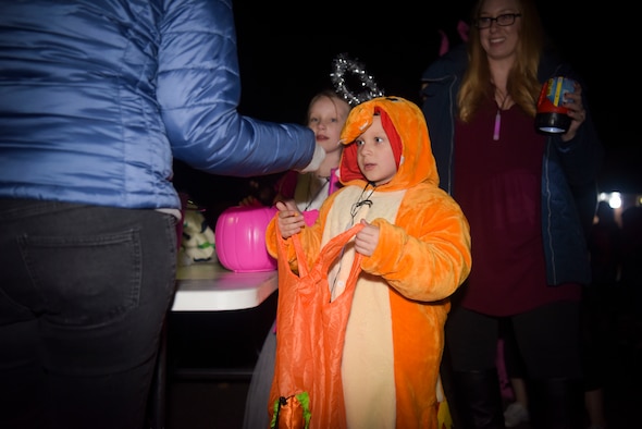A military family member, receives candy during Pumpkin Patrol in Beck Row, England, Oct 31, 2019. The Pumpkin Patrol is an event dedicated to the American tradition of trick-or-treating, nearly every house participating in some way. (U.S. Air Force photo by Senior Airman Alexandria Lee