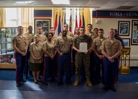 U.S. Marines with 6th Marine Corps District pose for a group photo after the promotion ceremony of LCpl. Devon Hinterlong at the 6MCD Headquarters aboard Marine Corps Recruit Depot Parris Island, South Carolina on Nov. 01, 2019. Hinterlong serves as an administrative specialist. (U.S. Marine Corps photo by Cpl. Jack A. E. Rigsby)