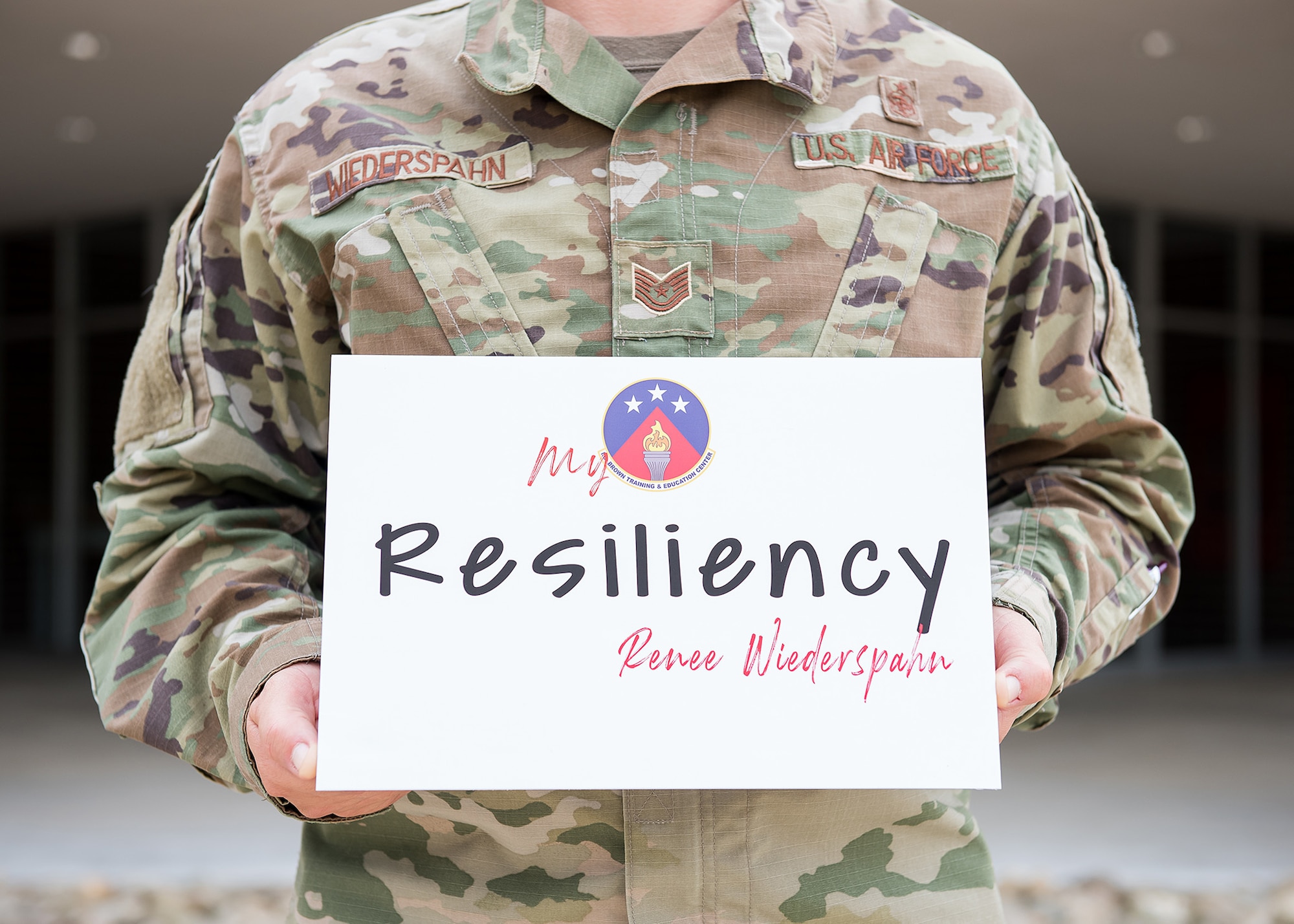 Holding a resiliency sign.