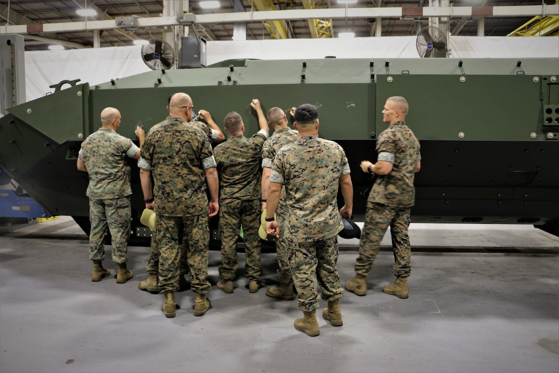 Marines from the 3rd Assault Amphibian Battalion—slated to receive the first of the Corps’ new Amphibious Combat Vehicles—sign the side of an unfinished ACV at a manufacturing facility in York, Pennsylvania, on Oct. 16, 2019. Marines from 3rd AA Bn. received the rare opportunity to visit the ACV’s main production facility and meet with the workforce building the vehicle.