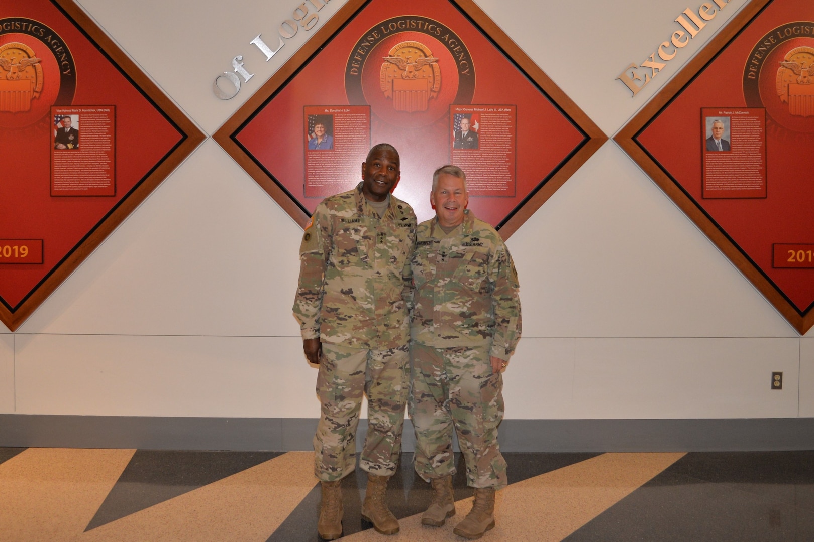 Two Army Lt. Generals pose in the McNamara Headquarters Complex Auditorium.