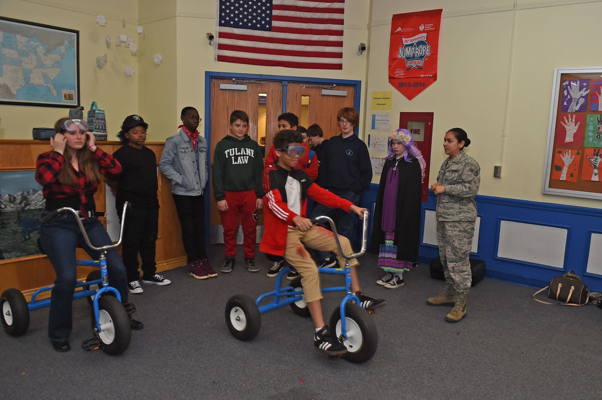 Children ride a tricycle with alcohol simulation goggles on