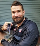 Runner posing with finisher's medal
