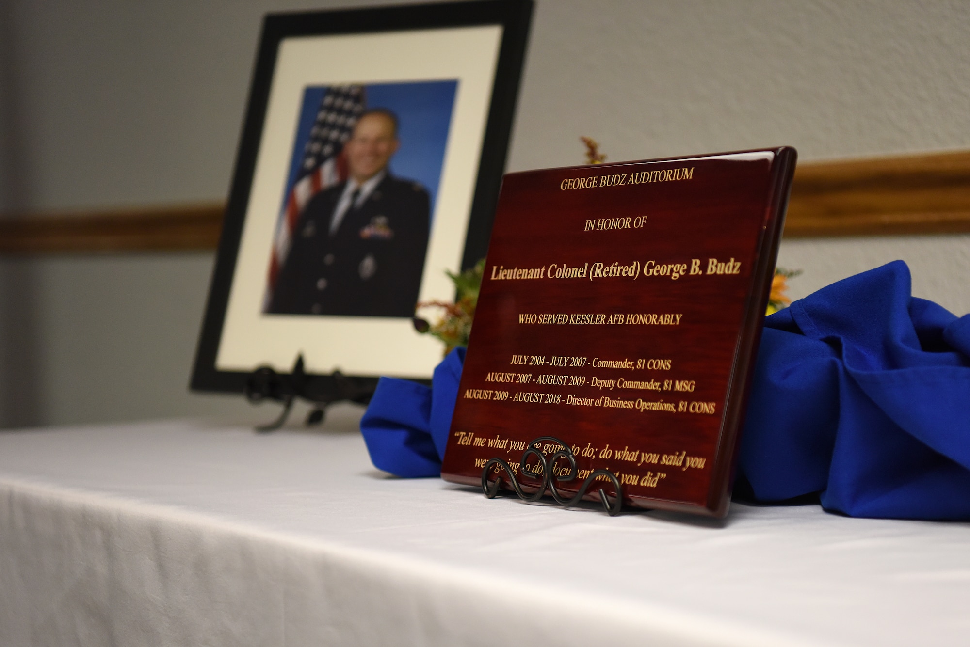 A plaque is displayed during the Sablich Center Auditorium room dedication ceremony for George Budz inside the Sablich Center at Keesler Air Force Base, Mississippi, Oct. 31, 2019. The auditorium has been renamed after Budz who passed away Aug. 3, 2018. Budz served as the 81st Contracting Squadron commander, the 81st Mission Support Group deputy commander and worked nine years in civil service after he retired as a lieutenant colonel. (U.S. Air Force photo by Senior Airman Suzie Plotnikov)