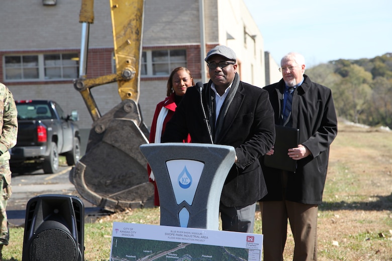 The speakers at the ceremony November 1, 2019, broke the ground at Swope Park Industrial Area. At the podium, Councilman Lee Barnes, representing the 5th Council District, delivered remarks emphasizing the most credit should go to the people and business who occupy the Swope Park Industrial Area as they have suffered the most and worked hard for the positive changes the longest.