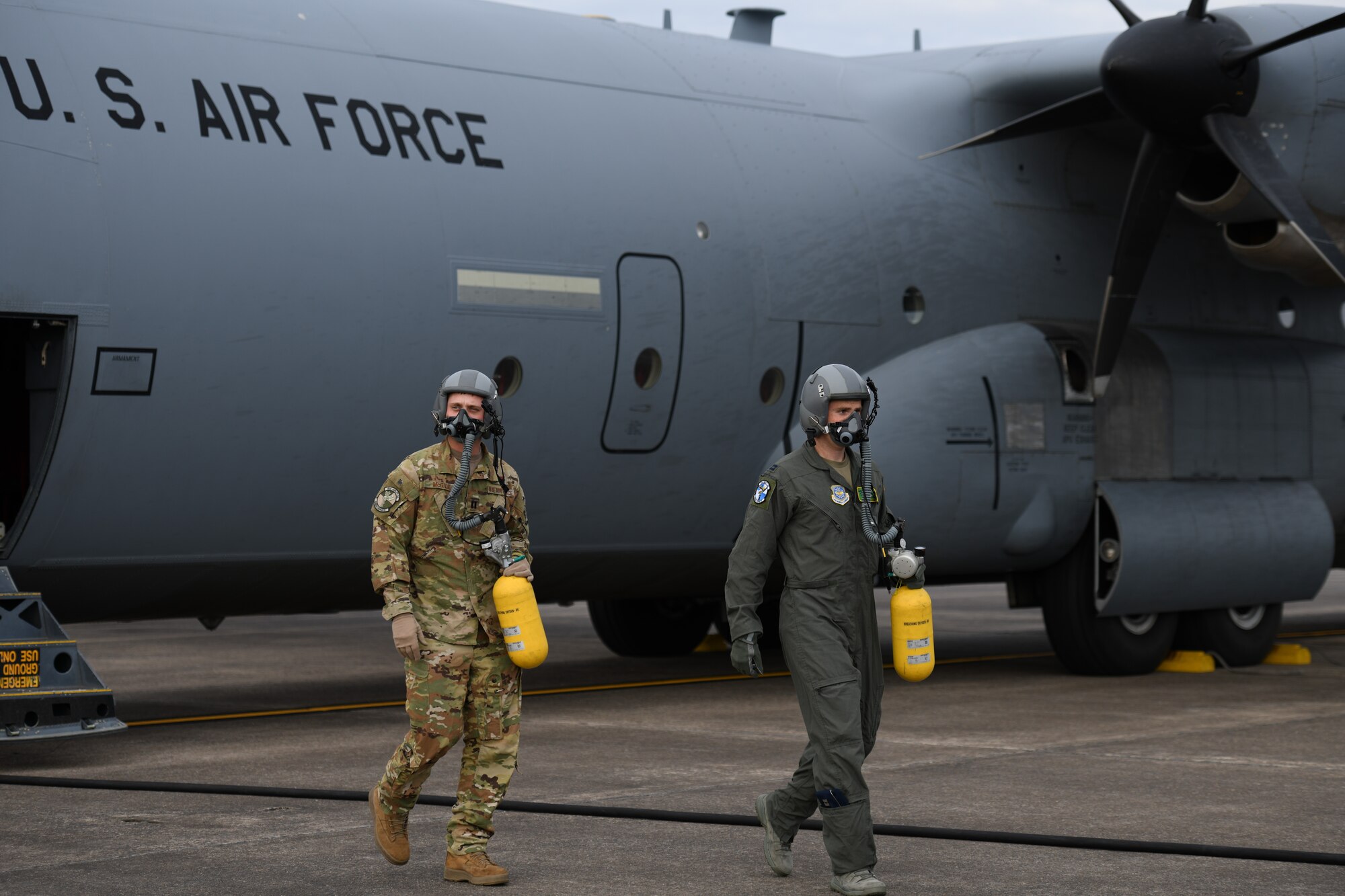 men step off a plane