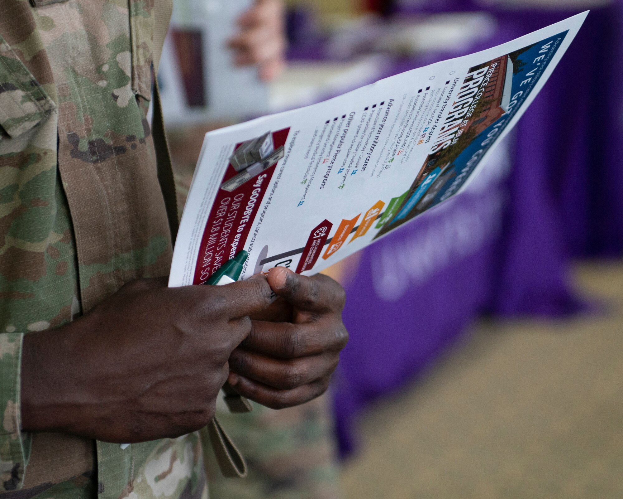 U.S. Army Pvt. Romario Osborne, a soldier assigned to the 6th Brigade Engineer Battalion, 4th Infantry Brigade Combat Team (Airborne), 25th Infantry Division, U.S. Army Alaska, gathers information about tuition programs during the Fall Education Fair at Joint Base Elmendorf-Richardson, Alaska, Oct. 31, 2019. The JBER Army Education Center held the event, which allowed more then 20 vendors to showcase different educational opportunities.