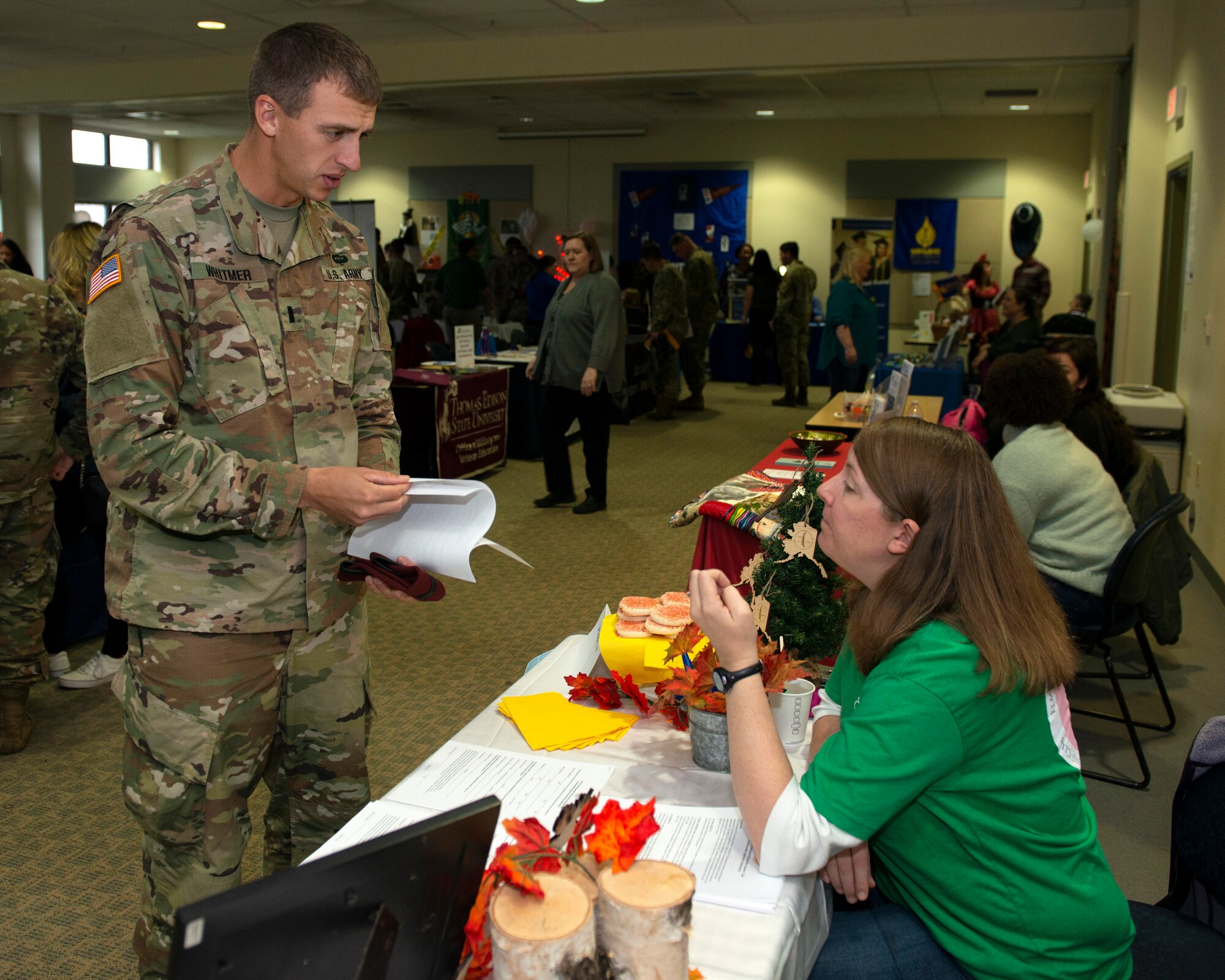 U.S. Army 1st Lt. Patrick Witmer, a platoon leader with the 6th Brigade Engineer Battalion, 4th Infantry Brigade Combat Team (Airborne), 25th Infantry Division, U.S. Army Alaska, learns about scholarships available for his spouse during the Fall Education Fair at Joint Base Elmendorf-Richardson, Alaska, Oct. 31, 2019. The JBER Army Education Center hosted the event, which allowed more than 20 vendors to showcase a variety of educational opportunities.