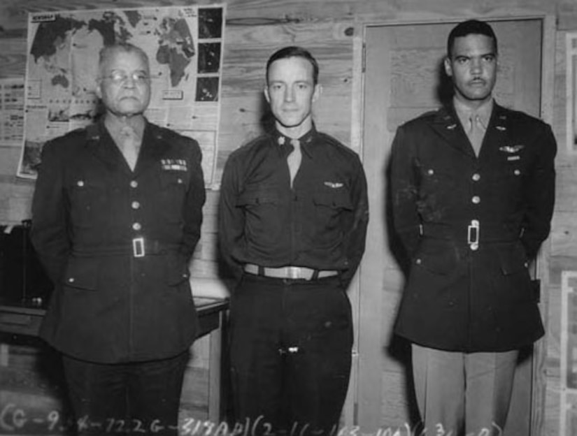 Three men in military uniforms stand for a photo.