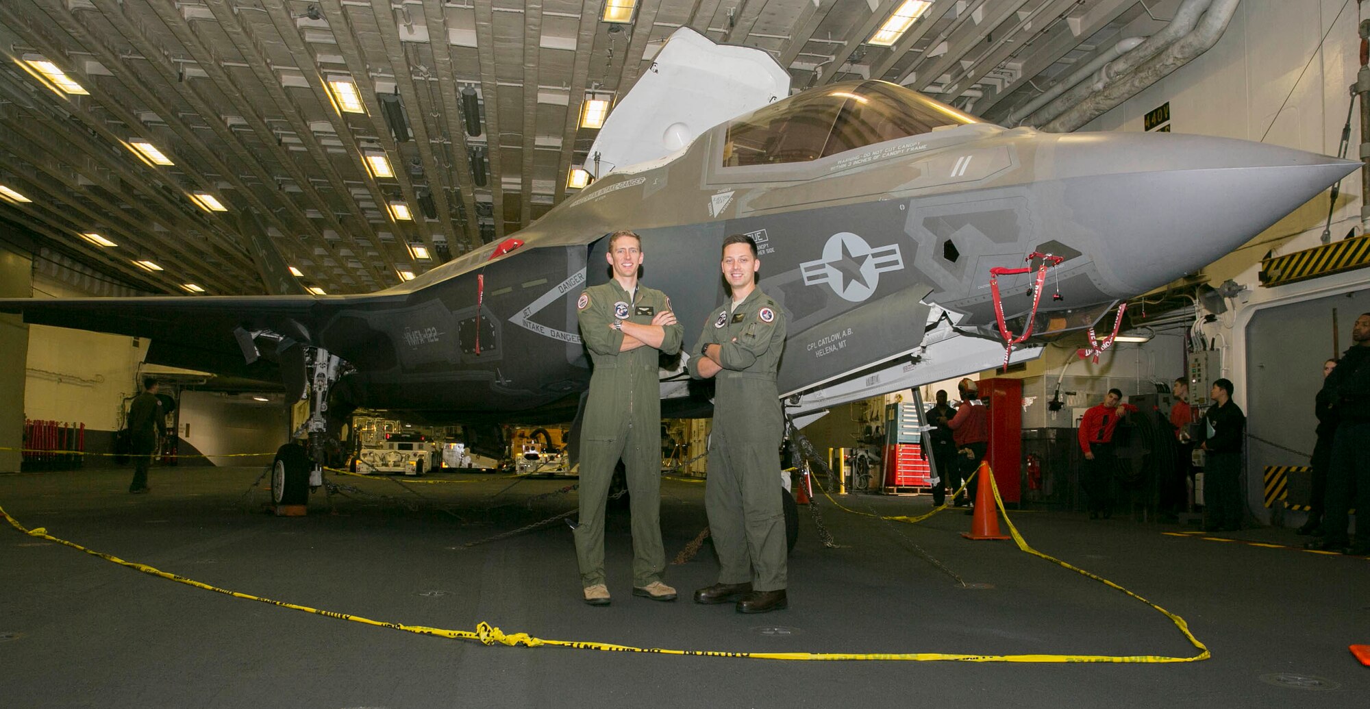 U.S. Air Force Capt. Spencer G. Weide, left, and Capt. Justin J. Newman, F-35B Lightning IIs pilots with Marine Fighter Attack Squadron (VMFA) 122, Marine Aircraft Group (MAG) 13, 3rd Marine Aircraft Wing (MAW), pose with an F-35 aboard the amphibious assault ship USS America (LHA 6) during routine operations in the eastern Pacific, Oct. 6, 2019.  Amphibious assault ships, such as the America, provide flexibility to the joint force by supporting a spectrum of air operations from fifth generation jets to heavy lift helicopters.(U.S. Marine Corps photo by Lance Cpl. Juan Anaya)