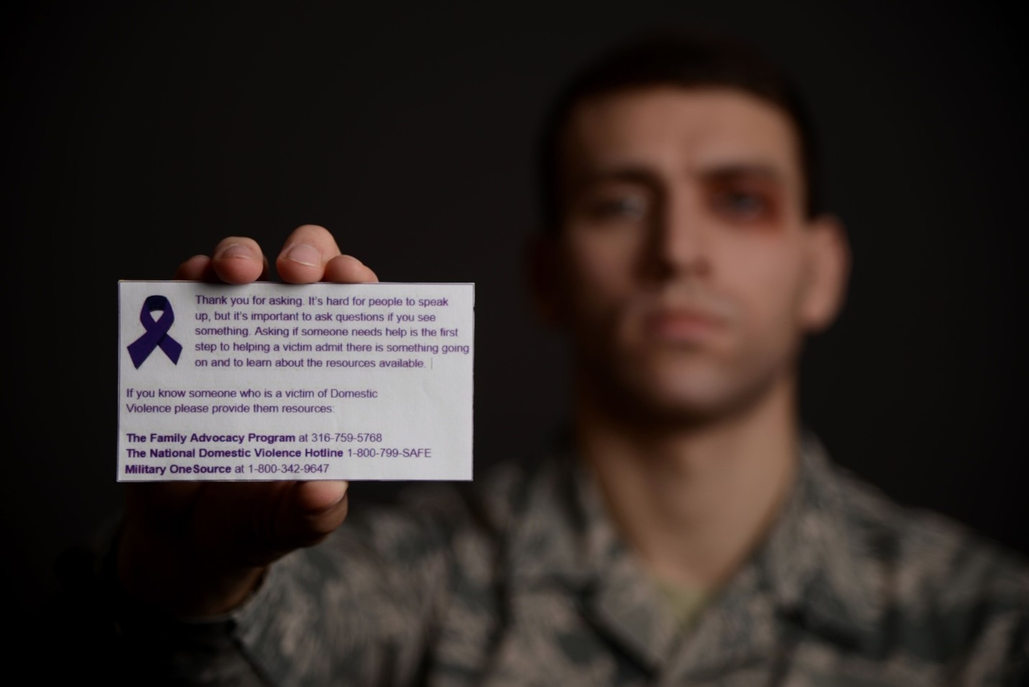Airman 1st Class Marc Garcia, 22nd Wing Staff Agencies photojournalist, holds up a Violence 
Prevention card Oct. 30, 2019, at McConnell Air Force Base, Kan. The cards were handed to concerned individuals who chose to speak up and ask about the volunteer’s black eye. Printed on each card was a message thanking the individual for speaking up, as well as further information on domestic violence. (U.S. Air Force photo by Airman 1st Class Nilsa E. Garcia)