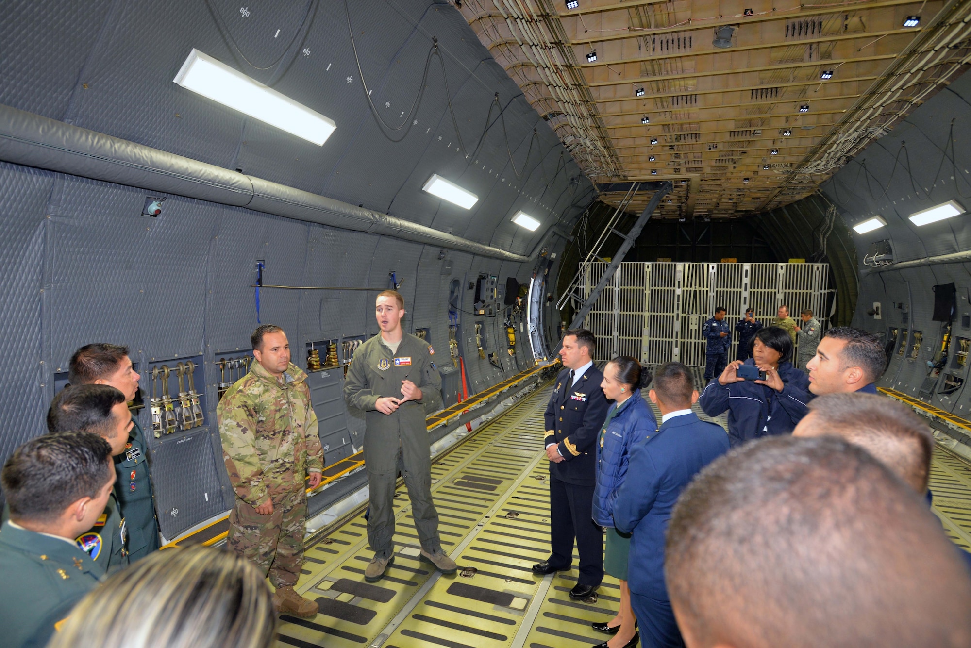 Tech. Sgt. Joshua Green, 356th Airlift Squadron loadmaster, describes the 433rd Airlift Wing’s C-5M Super Galaxy’s cargo carrying capabilities to Inter-American Air Forces Academy students Oct. 30, 2019 at Joint Base San Antonio-Lackland.