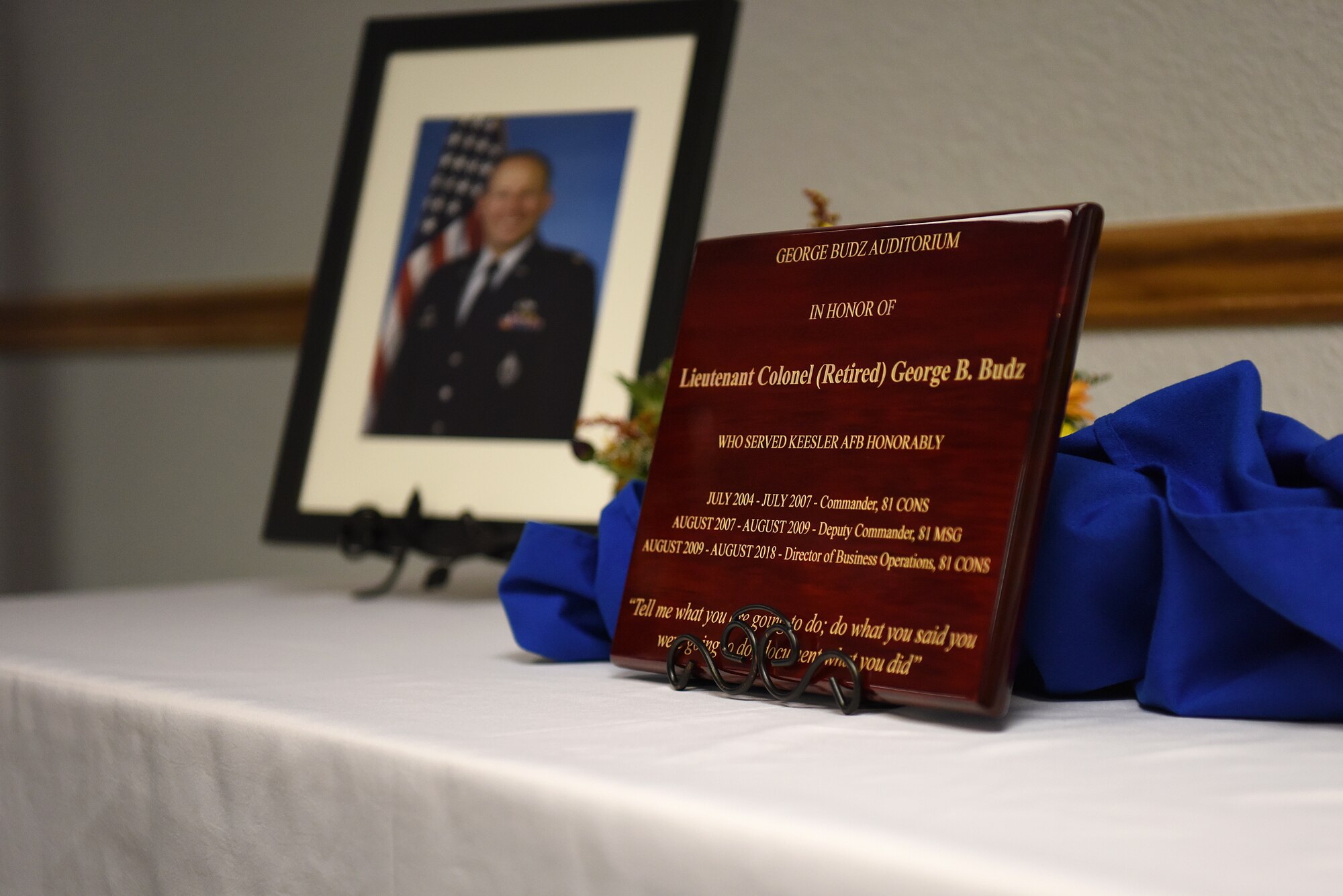A plaque is displayed during the Sablich Center Auditorium room dedication ceremony for George Budz inside the Sablich Center at Keesler Air Force Base, Mississippi, Oct. 31, 2019. The auditorium has been renamed after Budz who passed away Aug. 3, 2018. Budz served as the 81st Contracting Squadron commander, the 81st Mission Support Group deputy commander and worked nine years in civil service after he retired as a lieutenant colonel. (U.S. Air Force photo by Senior Airman Suzie Plotnikov)