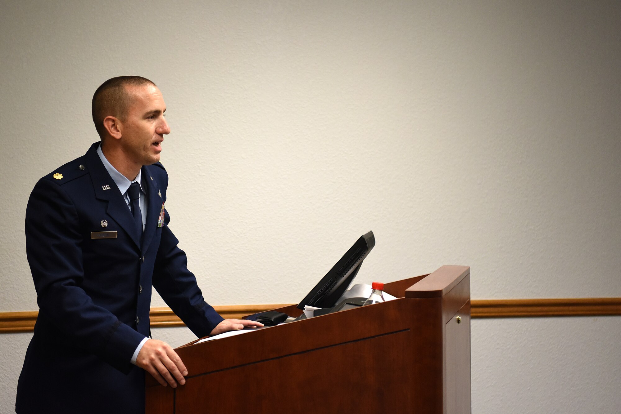 U.S. Air Force Maj. Bruce Hebert, 81st Contracting Squadron commander, gives remarks during the Sablich Center Auditorium room dedication ceremony for George Budz inside the Sablich Center at Keesler Air Force Base, Mississippi, Oct. 31, 2019. The auditorium has been renamed after Budz who passed away Aug. 3, 2018. Budz served as the 81st CONS commander, the 81st Mission Support Group deputy commander and worked nine years in civil service after he retired as a lieutenant colonel. (U.S. Air Force photo by Senior Airman Suzie Plotnikov)