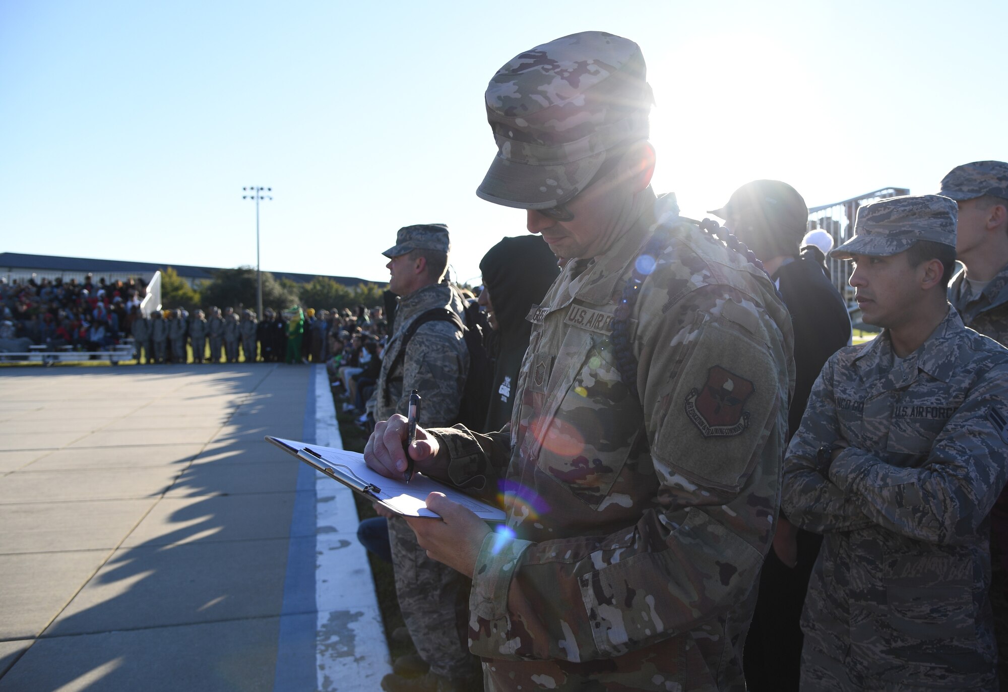 U.S. Air Force Master Sgt. David Gustafson, 334th Training Squadron flight chief, judges a performance during the 81st Training Group drill down on the Levitow Training Support Facility drill pad at Keesler Air Force Base, Mississippi, Nov. 1, 2019. Airmen from the 81st TRG competed in a quarterly open ranks inspection, regulation drill routine and freestyle drill routine. Keesler trains more than 30,000 students each year. While in training, Airmen are given the opportunity to volunteer to learn and execute drill down routines. (U.S. Air Force photo by Kemberly Groue)
