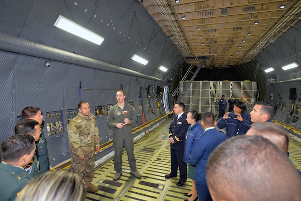 Tech. Sgt. Joshua Green, 356th Airlift Squadron loadmaster, describes the 433rd Airlift Wing’s C-5M Super Galaxy’s cargo carrying capabilities to Inter-American Air Forces Academy students Oct. 30, 2019 at Joint Base San Antonio-Lackland.