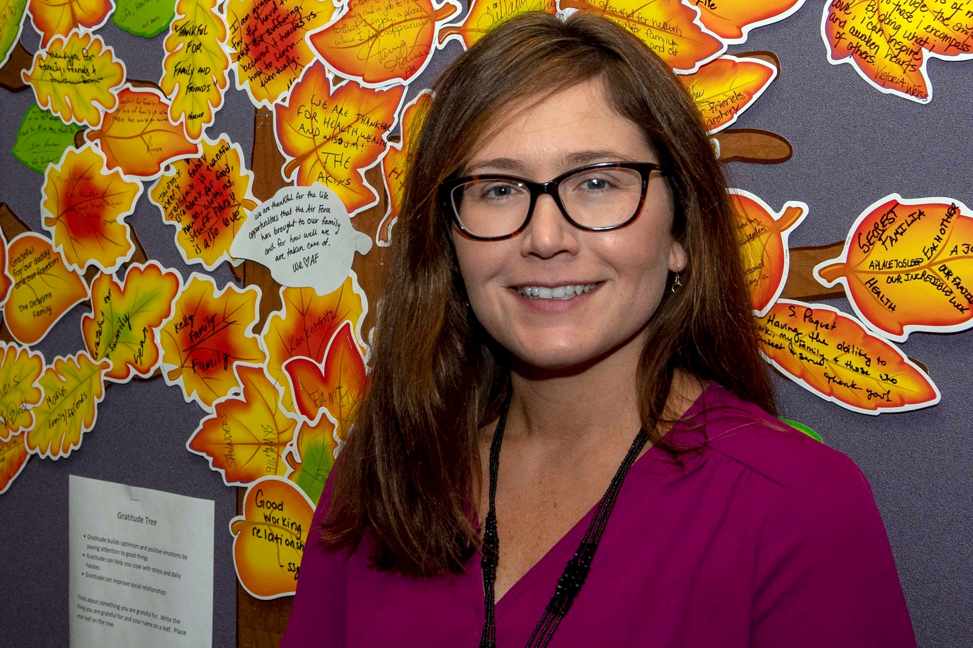 Jennifer S. Price, 916th Air Refueling Wing director of psychological health, poses for a photo in front of her Gratitude Tree.
