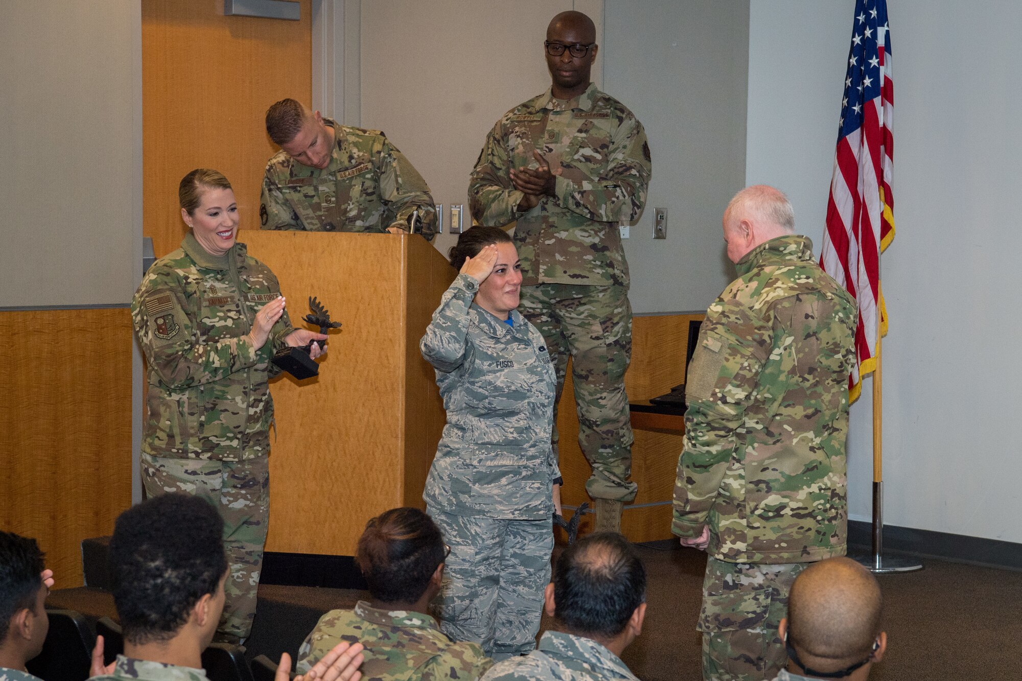 Senior Airman Dana Fusco, 514th Aircraft Maintenance Squadron member, 514th Air Mobility Wing, Joint Base McGuire-Dix-Lakehurst, N.J., salutes Col. Thomas O. Pemberton, 514th AMW commander, Nov. 2, 2019. Fusco received the Airman of the Quarter Award for the months of July through September. (U.S. Airforce photo by Senior Airman Ruben Rios)