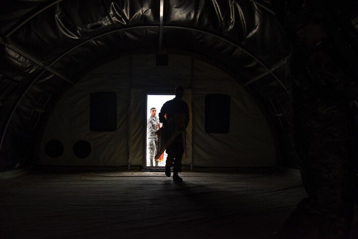Airmen assigned to the 355th Wing begin to deconstruct a tent during Exercise Bushwhacker 19-08 at Davis-Monthan Air Force Base, Arizona, Oct. 30, 2019. The Airmen assigned to different Air Force Specialty Codes throughout the base, but together learned basic tasks needed for deploying to an austere location to better execute the Dynamic Wing concept by having a multi-functional mentality. (U.S. Air Force photo by Senior Airman Mya M. Crosby)