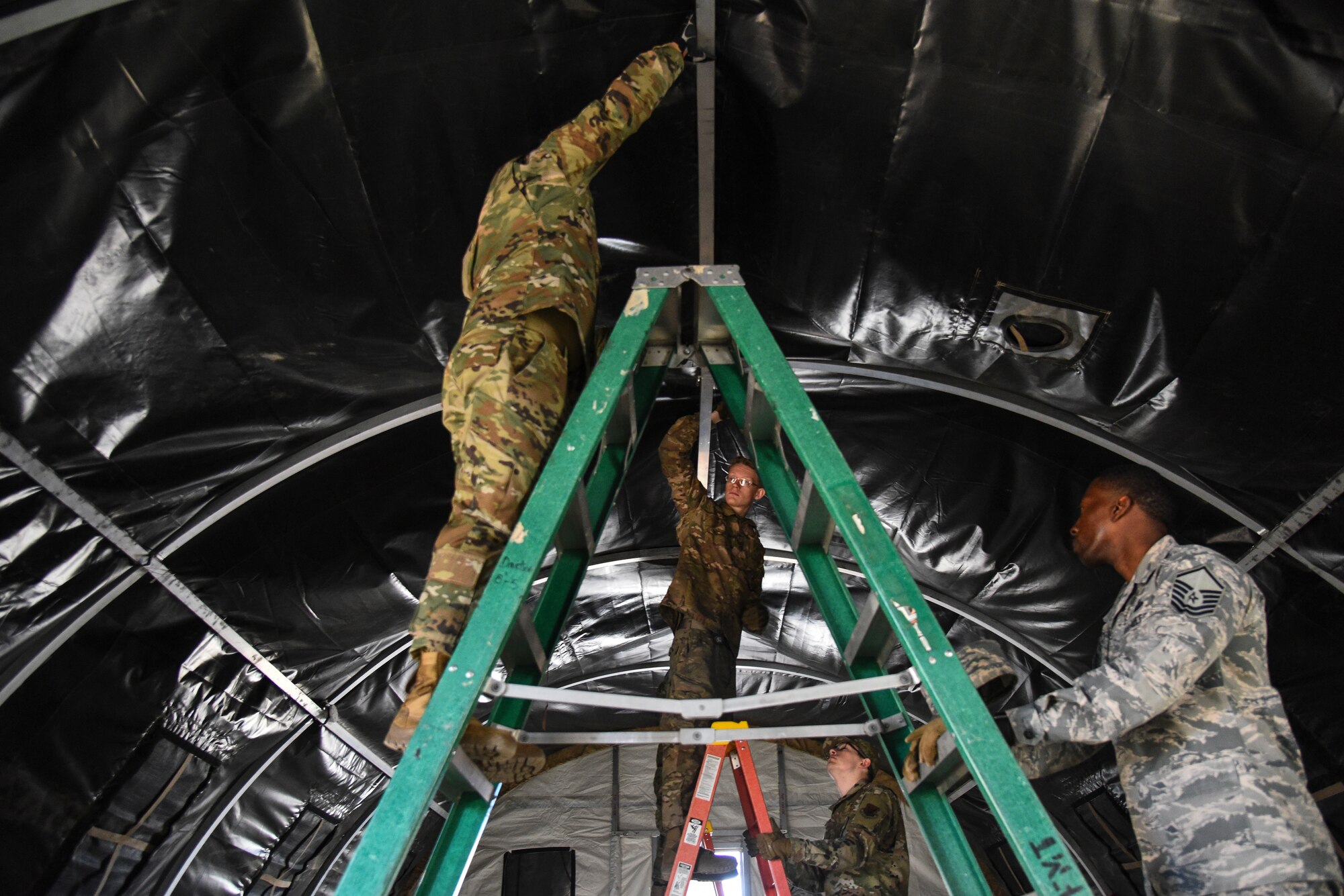U.S. Airmen assigned to the 355th Wing deconstruct a tent during Exercise Bushwhacker 19-08 at Davis-Monthan Air Force Base, Arizona, Oct. 30, 2019. One of DM’s focuses is to ensure all Airmen deploying out of Davis-Monthan to a forward operating location are multi-functional Airmen – executing their individual trades, while also being able to perform functions outside of their Air Force Specialty Codes. (U.S. Air Force photo by Senior Airman Mya M. Crosby)