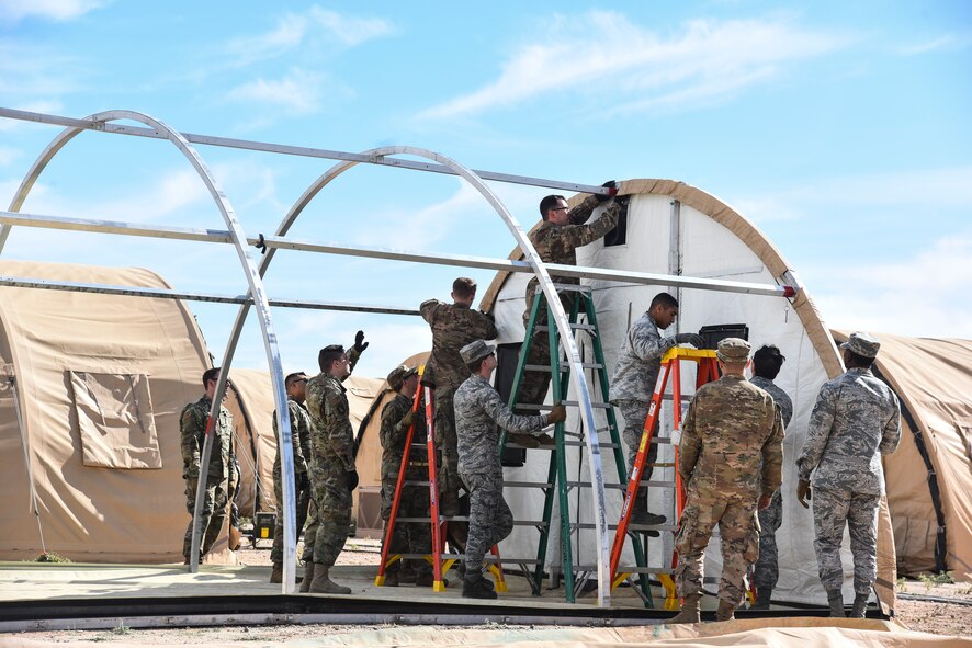 U.S. Airmen assigned to the 355th Wing deconstruct a tent during Exercise Bushwhacker 19-08 at Davis-Monthan Air Force Base, Arizona, Oct. 30, 2019. The Airmen assigned to different Air Force Specialty Codes throughout the base, but together learned basic tasks needed for deploying to an austere location to better execute the Dynamic Wing concept by having a multi-functional mentality. (U.S. Air Force photo by Senior Airman Mya M. Crosby)