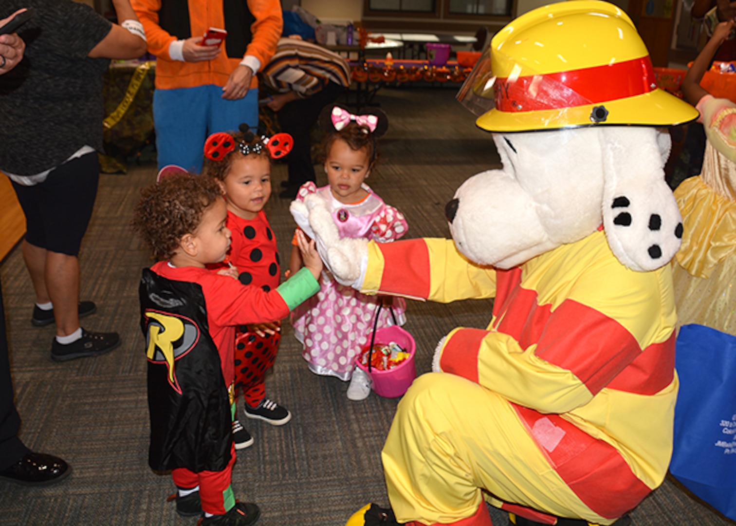 Sparky hi-fives children at Halloween event