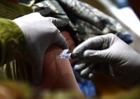 a photo of an airman receiving their flu vaccine