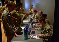 a photo of airmen going through medical processing lines