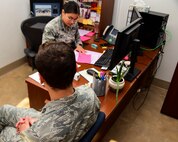 a photo of an airman ensuring their medical processing is ready to go before a simulated deployment