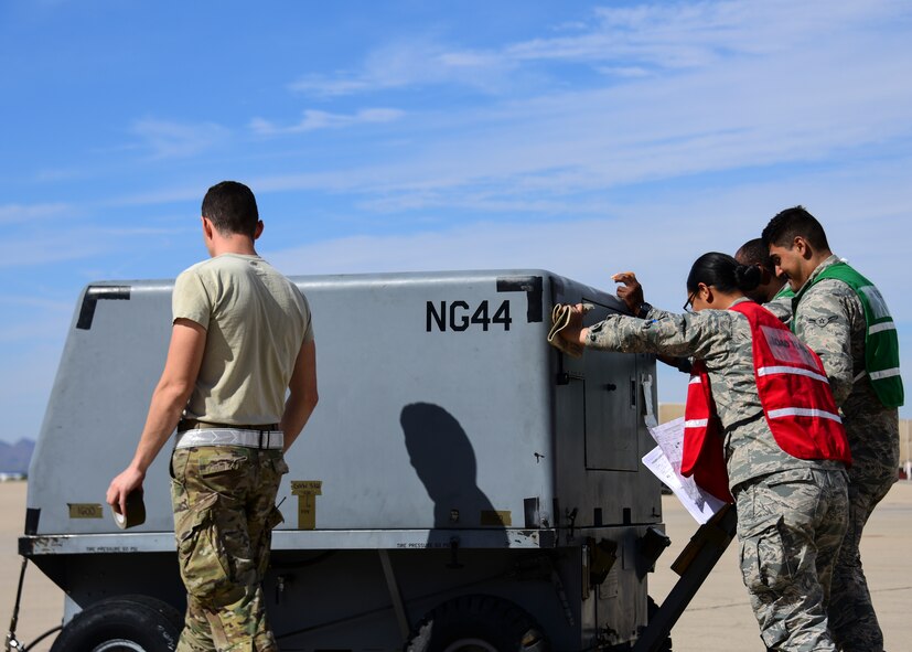 U.S. Air Force Airmen from the 355th Logistics Readiness Squadron cargo deployment function move a generator during exercise Bushwhacker 19-08 at Davis-Monthan Air Force Base, Arizona, Oct. 30, 2019. The CDF is critical in assisting Davis-Monthan to rapidly deploy in support of the Dynamic Wing concept. (U.S. Air Force photo by Airman 1st Class Jacob T. Stephens)
