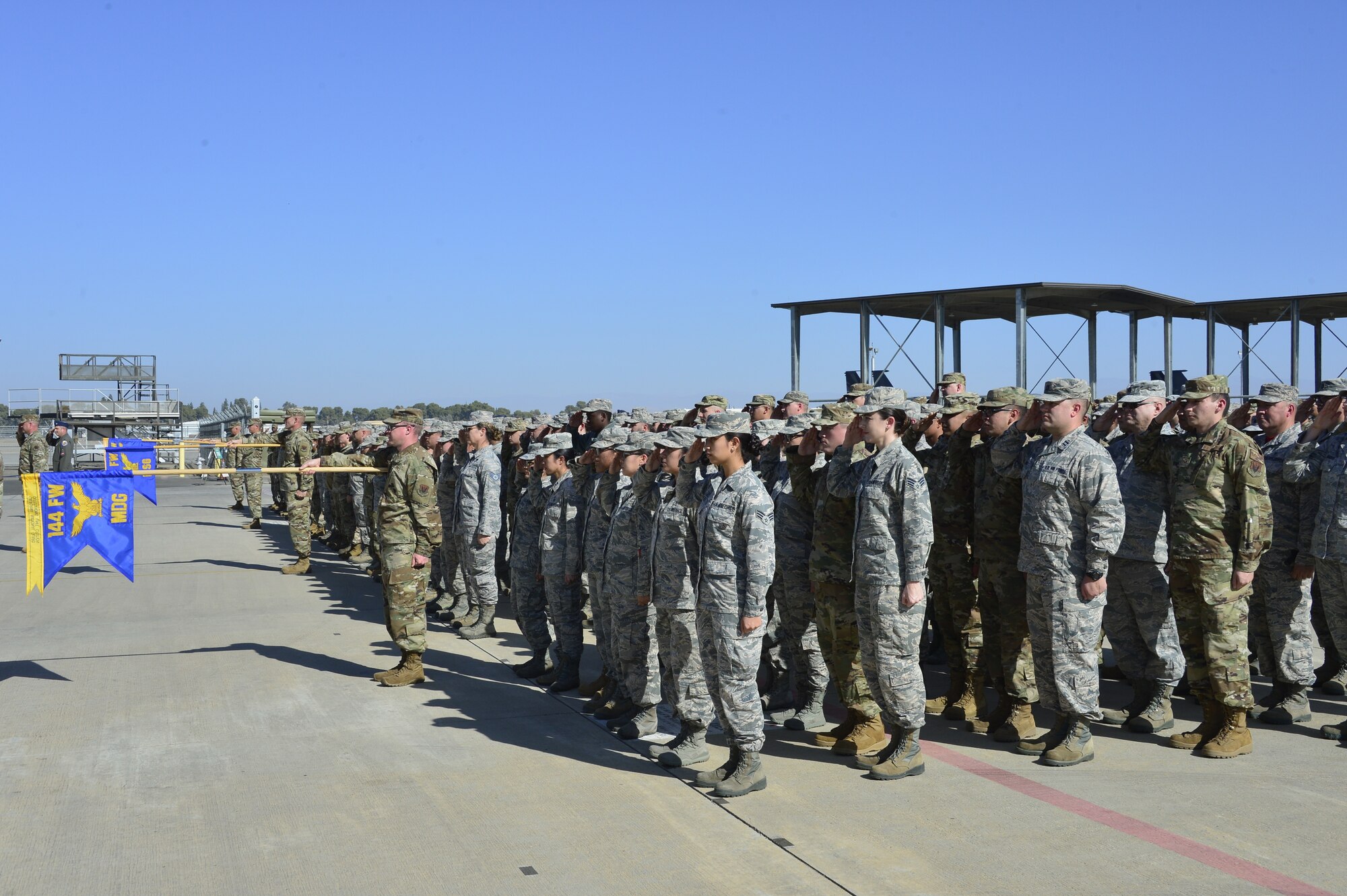 Airmen assigned to the 144th Fighter Wing salute the official party at the Assumption of Command ceremony for Col. Jeremiah Cruz,144th Fighter Wing commander, at the Fresno Air National Guard Base Oct. 2, 2019. (Air National Guard photo by Master Sgt. Charles Vaughn)