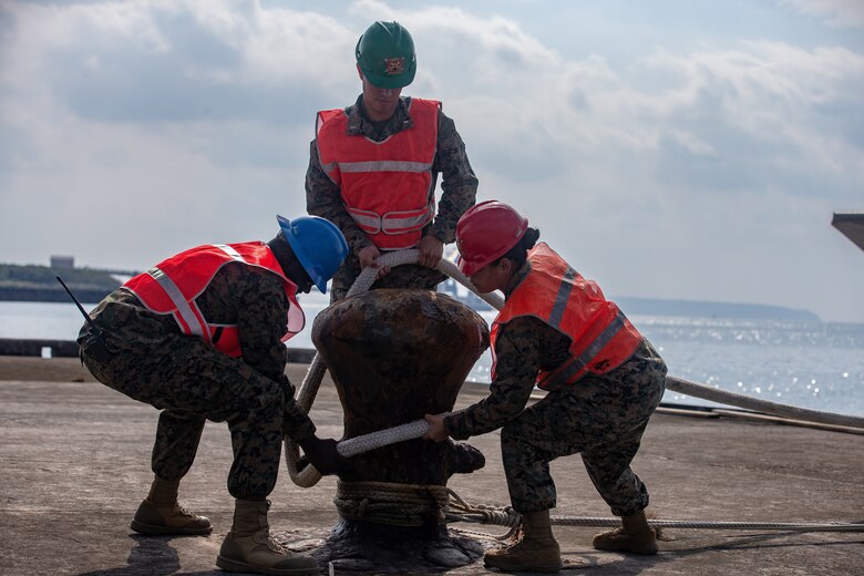 U.S. Marines with 12th Marine Regiment, 3rd Marine Division, and U.S. Soldiers with 97th Transportation Company, 10th Support Group, work together to quickly embark transportation vehicles and a High Mobility Artillery Rocket System on the U.S. Army Vessel Harpers Ferry (LCU-2022) during a joint service HIMARS embarkation training exercise in Kin, Okinawa, Japan, Oct. 31, 2019. This event marks the first time a Marine HIMARS was loaded on to an Army landing craft in the Indo-Pacific. Strategic mobility is key in the Indo-Pacific and the ability to transport the HIMARS over water is a vital capability that the 3rd Marine Division is now able to expand upon by partnering with the 10th Support Group. (U.S. Marine Corps photo by Lance Cpl. D’Angelo Yanez)